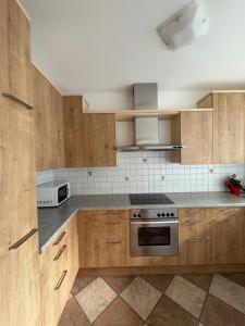 a kitchen with wooden cabinets and a stove top oven at Apartment Apfel in Naturno +4 photos