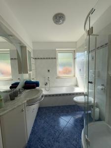 a bathroom with a tub and a sink and a shower at Apartment Apfel in Naturno