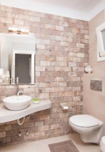 a bathroom with a sink and a toilet at Skopelitis Village in Katapola