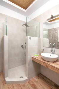 a bathroom with a sink and a shower at Skopelitis Village in Katapola