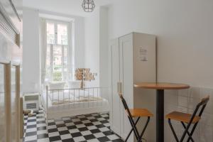 a kitchen with a table and two chairs and a refrigerator at BackpackerBerlin in Berlin