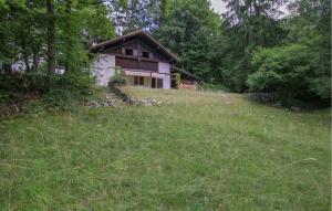 a house in the middle of a grass field at Ladino House in San Lorenzo in Banale