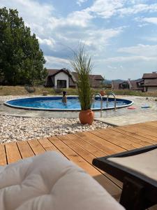 a swimming pool with a person in the water at Pointview House Gesha in Dryanovo