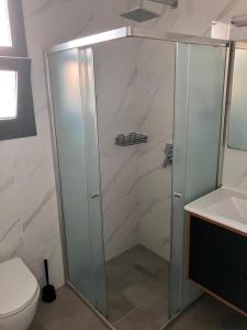 ein Badezimmer mit Dusche, Toilette und Waschbecken in der Unterkunft Sokrates in Larnaka