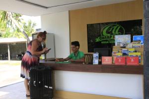 a woman standing at a cash register with a man at Vico hotel in Nusa Dua