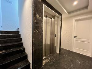 a hallway with a door and stairs in a room at Sliema Trendy Rooftop Pool House in Sliema