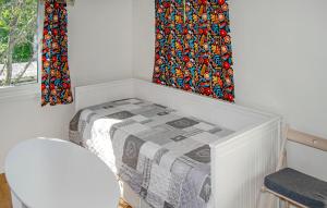 a white room with a bed and a window at Nice Home In Norrtälje in Norrtälje