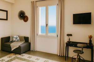a living room with a window and a chair and a desk at Villa Bona in Termini Imerese