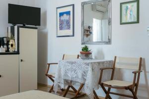 a dining room with a table and chairs and a mirror at Old Town Port Apartments in Dubrovnik