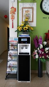 a machine with magazines and flowers in a room at Five Hotel in Seremban +43 photos