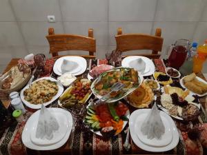 a table with many plates of food on it at KARNEL Hotel in Sanain