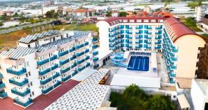 an aerial view of a building with a swimming pool at Tugra Suit Hotel Halal All Inclusive in Alanya