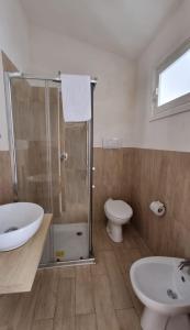 a bathroom with a shower and a toilet and a sink at Monolocale Lamorè in Favignana +1 photo