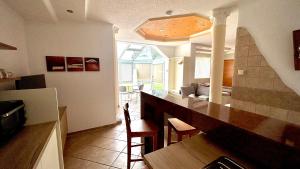 a kitchen with a counter and a living room at Ferienwohnungen Panorama Harrys Bike Tours in Villach