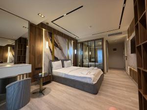 a bedroom with a large bed and a bathroom at Golden Stone Hotel Akçay in Edremit