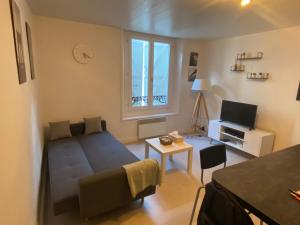 ナンシーにあるAppart Hotel - Les Cosy De Nancy - Place du marché, proche gareのベッドとテレビのある小さな寝室