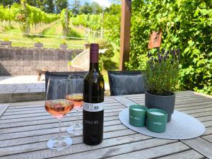 a bottle of wine and a glass on a table at Wein & Wohnen MATZL - Ferienwohnung in Fürstenfeld