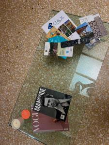 a glass table with a magazine on top of it at Asteras City Apartments in Chios