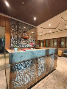 a lobby with a bar with a design on the wall at The Hub Link in Mumbai