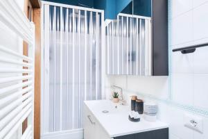 a bathroom with a white sink and a mirror at Easylife - Appartamento di Design in Milan +16 photos
