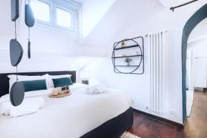 a white bedroom with a bed and a window at Easylife - Appartamento di Design in Milan