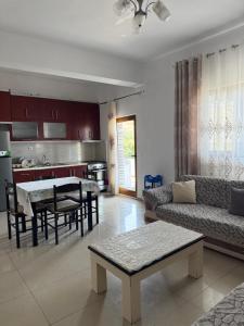a living room with a couch and a table at Villa Neimi in Ksamil