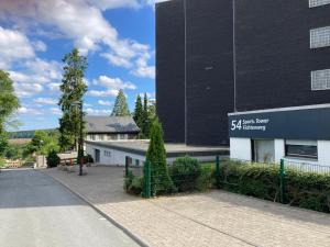 a building with a sign on the side of it at Francis Appartement am Mountainbike-Park in Winterberg