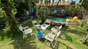 a group of chairs and a table next to a pool at Mộc Sơn Homestay in Mộc Châu +27 photos