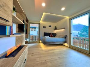 a bedroom with a bed and a large window at Lidia & Orfeo in Bormio