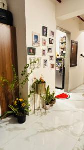 a room with potted plants and pictures on the wall at Sunny Urban Retreat in Mumbai