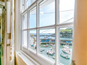 a window with a view of a harbor at Memory Cottage in Mevagissey
