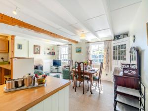 a kitchen with a table and a dining room at Memory Cottage in Mevagissey +15 photos