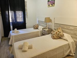 a room with two beds with towels on them at Apartamento Caballito de Mar con PARKING in L'Estartit