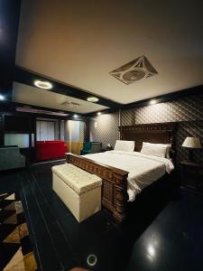a bedroom with a large bed and a couch at Sea View Suites in Karachi +26 photos