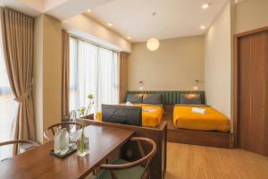 a hotel room with a bed and a desk with a desk sidx sidx sidx sidx at Vừng Hotel in Hue +54 photos
