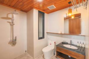 a bathroom with a toilet and a sink at Vừng Hotel in Hue