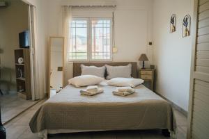 a bedroom with a bed with two towels on it at Miranta's Studios in Mytilene