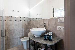 a bathroom with a white sink and a toilet at San Filadelfo 