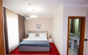 a bedroom with a large bed and a sink at Holiday Resort in Velika Slatina +28 photos
