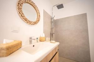a bathroom with a sink and a mirror on the wall at Villa Sahel Bleu in Essaouira +29 photos