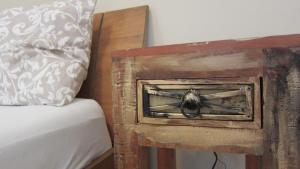 a bug in a wooden box next to a bed at Gara Cottage Private escape with modern comfort and spacious covered terrace in Garabonc