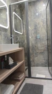 a bathroom with a shower and a sink at Gara Cottage Private escape with modern comfort and spacious covered terrace in Garabonc +35 photos
