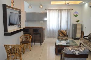 a living room with a couch and a table at Ananta - Rishikesh Luxurious 2BHK in Rishīkesh