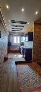 a room with a kitchen with a table and a rug at Egypt Soul hotel retreat in Luxor +9 photos