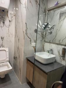 a bathroom with a sink and a toilet at Sun twilight studio in Greater Noida
