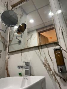 a bathroom with a sink and a mirror at Sun twilight studio in Greater Noida +1 photo