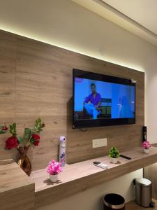 a flat screen tv on a wall in a room at Sun twilight studio in Greater Noida