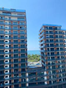two tall buildings with the ocean in the background at Blue Horizon in Batumi