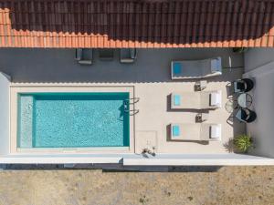 an overhead view of a house with a swimming pool at Arokaria Holiday Houses in Platanes
