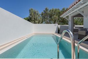 a swimming pool in the backyard of a house at Arokaria Holiday Houses in Platanes
